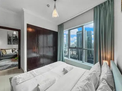 a bedroom with a large bed with a large window at 2204 DXB Marina, KingBed, Steps to Tram, Clubs & Dining, Bay Central in Dubai