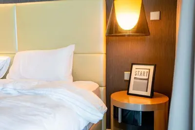 a bedroom with a bed and a clock on a table at Exquisite 1BR at DAMAC Paramount Tower D in Dubai