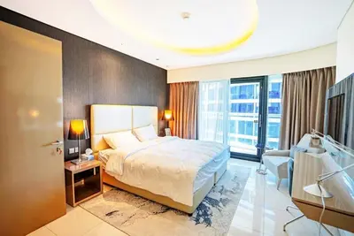 a hotel room with a bed and a large window at Exquisite 1BR at DAMAC Paramount Tower D in Dubai