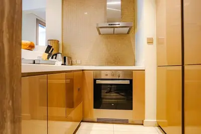 a kitchen with a stove and a sink at Exquisite 1BR at DAMAC Paramount Tower D in Dubai