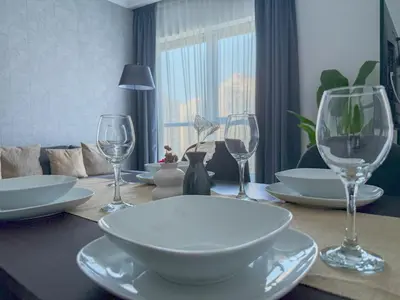 a table with plates and wine glasses on it at Marina View-2BR,6 Guests, Central location, Marina Walk in Dubai