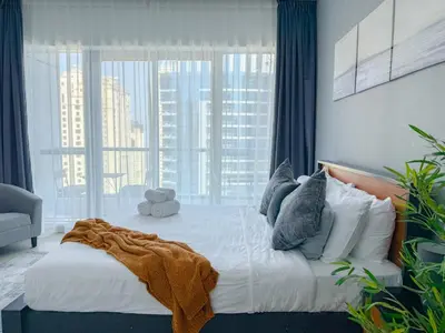 a bedroom with a large bed with a large window at Marina View-2BR,6 Guests, Central location, Marina Walk in Dubai