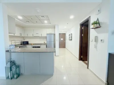 a kitchen with white cabinets and a counter top at Marina View-2BR,6 Guests, Central location, Marina Walk in Dubai