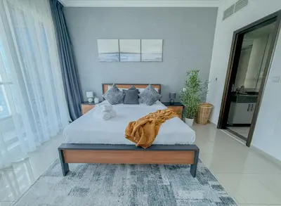 a bedroom with a bed with a blanket on it at Marina View-2BR,6 Guests, Central location, Marina Walk in Dubai