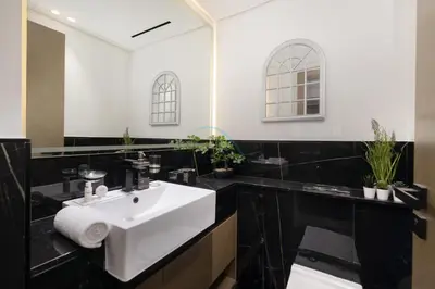 a bathroom with a white sink and a mirror at Creek Harbour Views 1BR, Just Minutes from Ras Al Khor Wildlife Sanctuary and Short Stroll to Zabeel Stadium, Binghatti Creek, Al Jaddaf by Deluxe Holiday Homes in Dubai