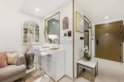 a living room with a couch and a table at Creek Harbour Views 1BR, Just Minutes from Ras Al Khor Wildlife Sanctuary and Short Stroll to Zabeel Stadium, Binghatti Creek, Al Jaddaf by Deluxe Holiday Homes in Dubai
