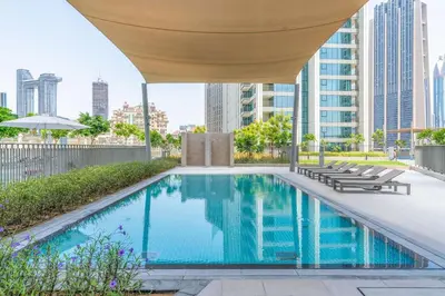 a swimming pool with a canopy over it with buildings at Luxury 3 bed with Burj Khalifa and Dubai Skyline View in Dubai