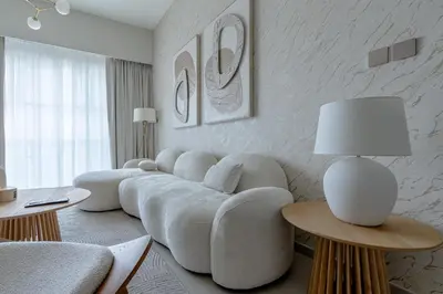 a living room with a white couch and tables at Nasma Luxury stays- Luxury-highfloor-iconic location in Dubai
