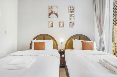 two beds sitting next to each other in a bedroom at Forte 4BR Luxury Dubai Opera & BLVD Views PS5 in Dubai