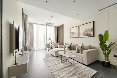 a living room with a couch and a table at FIRST CLASS 3BR Trendy Luxe Getaway in Dubai