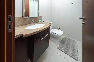 a bathroom with a sink and a toilet at Urban Skyline Haven Near Burj Khalifa in Dubai