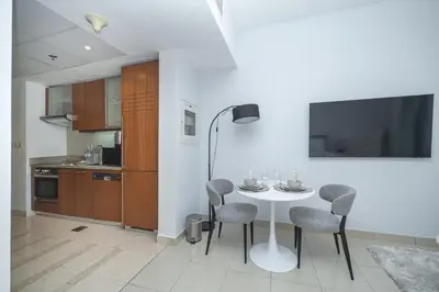 a kitchen and dining room with a table and chairs at Urban Skyline Haven Near Burj Khalifa in Dubai