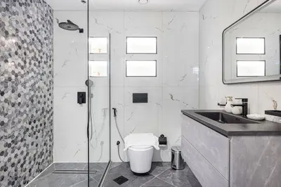 a bathroom with a shower and a toilet and a sink at StayMada - Torch Tower Marina Walk Gym and Sauna in Dubai