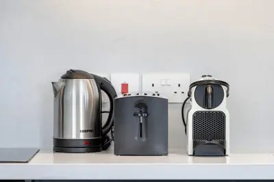 three appliances sitting on a counter in a kitchen at StayMada - Torch Tower Marina Walk Gym and Sauna in Dubai
