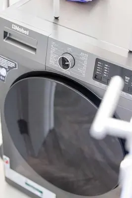 a close up of a washing machine with its door open at StayMada - Torch Tower Marina Walk Gym and Sauna in Dubai