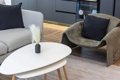 a living room with a couch and a chair and a table at StayMada - Torch Tower Elegant Marina Retreat in Dubai