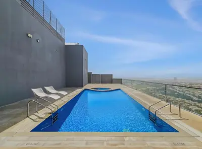 a swimming pool on the roof of a building at New 1BR with Rooftop Pool and Amazing View in Dubai