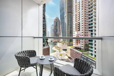 a balcony with a table and chairs and a view of a city at StayMada - Torch Tower Stunning Balcony City Views in Dubai