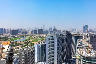 an aerial view of a city with tall buildings at Comfy 1BR apartment in Sport City in Dubai