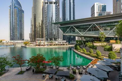 a river in a city with tall buildings at Vacay Lettings - Lake Terrace JLT - Walk to Metro in Dubai