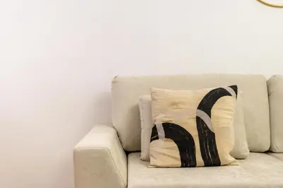 a pillow sitting on a couch in a room at Vacay Lettings - Lake Terrace JLT - Walk to Metro in Dubai