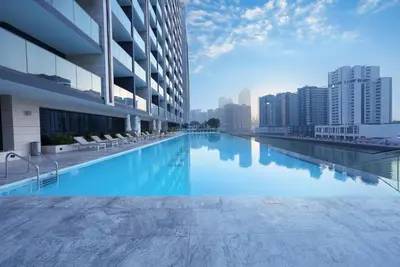 a swimming pool on the roof of a building at Premium Stay at High-Floor Trillionaire Studio in Dubai