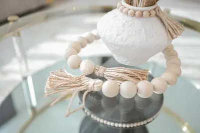 a pearl necklace on a glass table at Luxury 2-Bedroom Apartment with Stunning City Views By Norbu Holiday Homes in Dubai