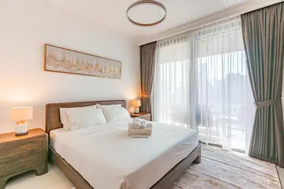 a bedroom with a bed and a large window at Luxury 2-Bedroom Apartment with Stunning City Views By Norbu Holiday Homes in Dubai