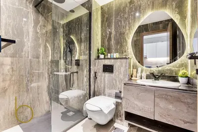 a bathroom with a sink and a toilet and a mirror at Bookable Studio Room Joya Blanca,Arjan with Tennis court access in Dubai