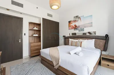 a bedroom with a large bed and a closet at Close to Ras Al Khor Wildlife Sanctuary, Just Minutes from Dubai Mall and Burj Khalifa, and Surrounded by Exceptional Amenities - Harbour Views Tower 1, Dubai Creek Harbour by Deluxe Holiday Homes in Dubai