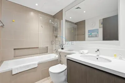 a bathroom with a sink and a toilet and a tub at Close to Ras Al Khor Wildlife Sanctuary, Just Minutes from Dubai Mall and Burj Khalifa, and Surrounded by Exceptional Amenities - Harbour Views Tower 1, Dubai Creek Harbour by Deluxe Holiday Homes in Dubai