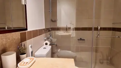 a bathroom with a shower with a toilet and a sink at Chic Downtown Studio Few Steps to Burj Khalifa by Simply Comfort in Dubai