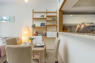 a kitchen and dining room with a table and chairs at VayK - Great 1BR in Downtown near Burj Khalifa in Dubai
