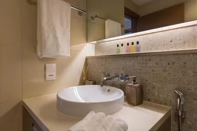 a bathroom with a white sink and a mirror at VayK - Great 1BR in Downtown near Burj Khalifa in Dubai