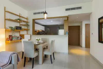 a kitchen and dining room with a table and chairs at VayK - Great 1BR in Downtown near Burj Khalifa in Dubai