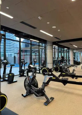 a gym with several cardio machines in a building at Bright 1BR - Unit 1806 - City Views & Fast Wi-Fi in Dubai