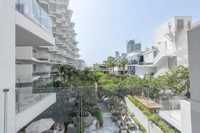 an apartment building with a balcony with trees and plants at Five Palm Luxury Stay 2BR with Pool & Beach Access in Dubai