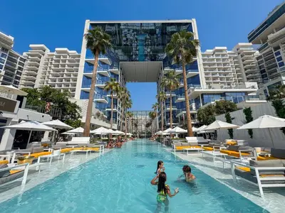 two girls in the swimming pool at a resort at Five Palm Luxury Stay 2BR with Pool & Beach Access in Dubai