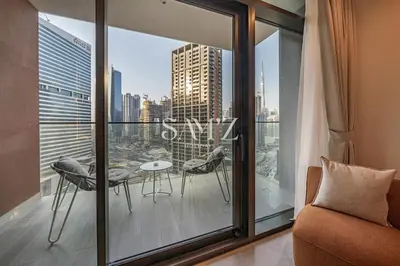 a room with a balcony with a table and chairs at Modern Studio - Unit 1705 - Near Downtown in Dubai