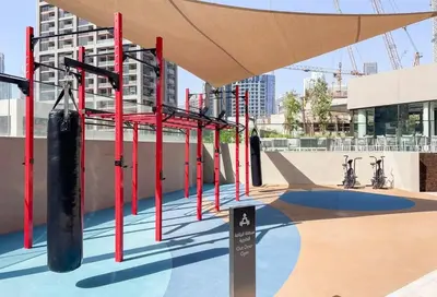 a gym with red and black equipment on top of a building at Modern Studio - Unit 1705 - Near Downtown in Dubai