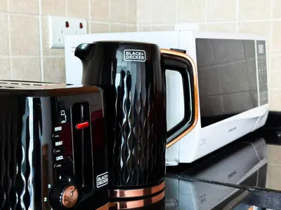 a black coffee maker sitting on a counter next to a microwave at Khayali Marina Holiday Homes Dubai Marina JBR in Dubai