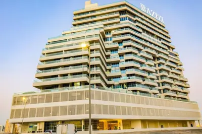 a tall building with a sign on it at Huge Balcony Overlooking Creek Harbour with Glimpses of Burj Khalifa, Just Minutes from Zabeel Stadium, Azizi Aliyah Residence, Al Jaddaf by Deluxe Holiday Homes in Dubai