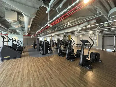 a gym with a row of treadmills and ellipticals at Chic 3BR in Downtown with Burj Khalifa View in Dubai
