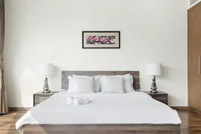 a bedroom with a large white bed with two night stands at VayK - Spacious 2BR in JLT with Marina Views in Dubai