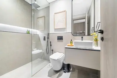 a bathroom with a shower and a toilet and a sink at VayK - Modern Studio with Great Amenities in Dubai