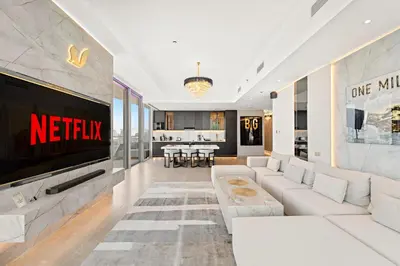 a living room with a couch and a tv at VayK - Ultra-Luxury 3BR Marina Retreat with Stunning View in Dubai