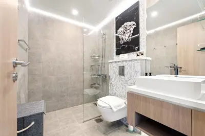 a bathroom with a toilet and a sink and a shower at VayK - Ultra-Luxury 3BR Marina Retreat with Stunning View in Dubai