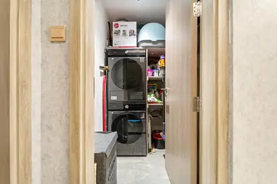 a kitchen with a microwave and a washer and dryer at VayK - Ultra-Luxury 3BR Marina Retreat with Stunning View in Dubai
