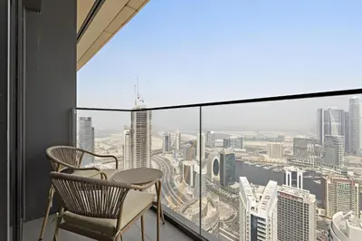 a balcony with two chairs and a view of the city at VayK - Stylish 1BR in Prime Downtown Location in Dubai