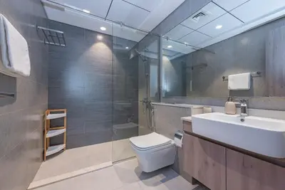 a bathroom with a sink and a toilet and a shower at VayK - Brand New 1BR in Dubai Hills in Dubai